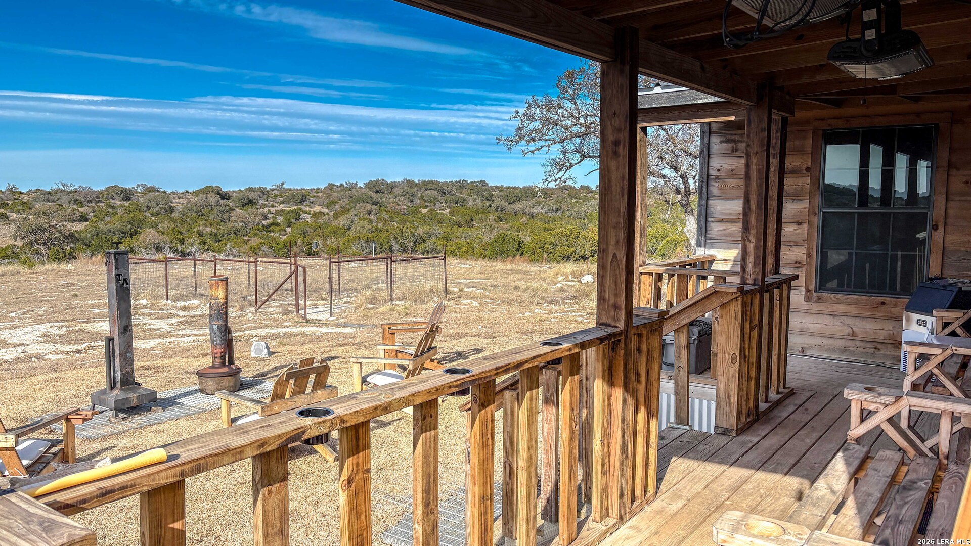 15019 County Road 310 Rocksprings, TX 78880 - Photo 15 of 90 a view of a balcony with chairs and wooden floor