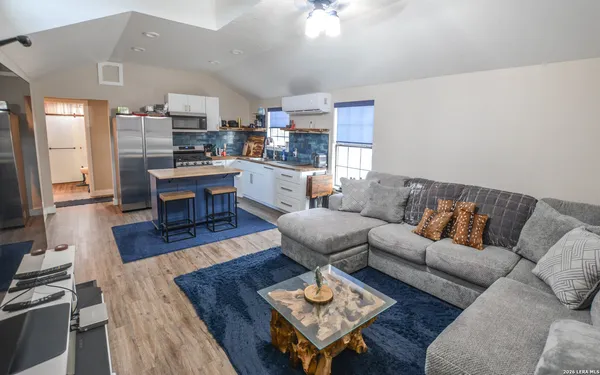 a living room with furniture window and a flat screen tv