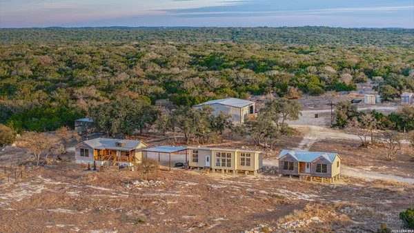 a view of a patio with a table and chairs