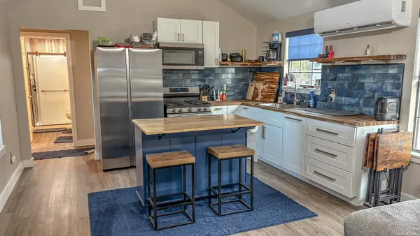 a bathroom with a sink a toilet a mirror and vanity