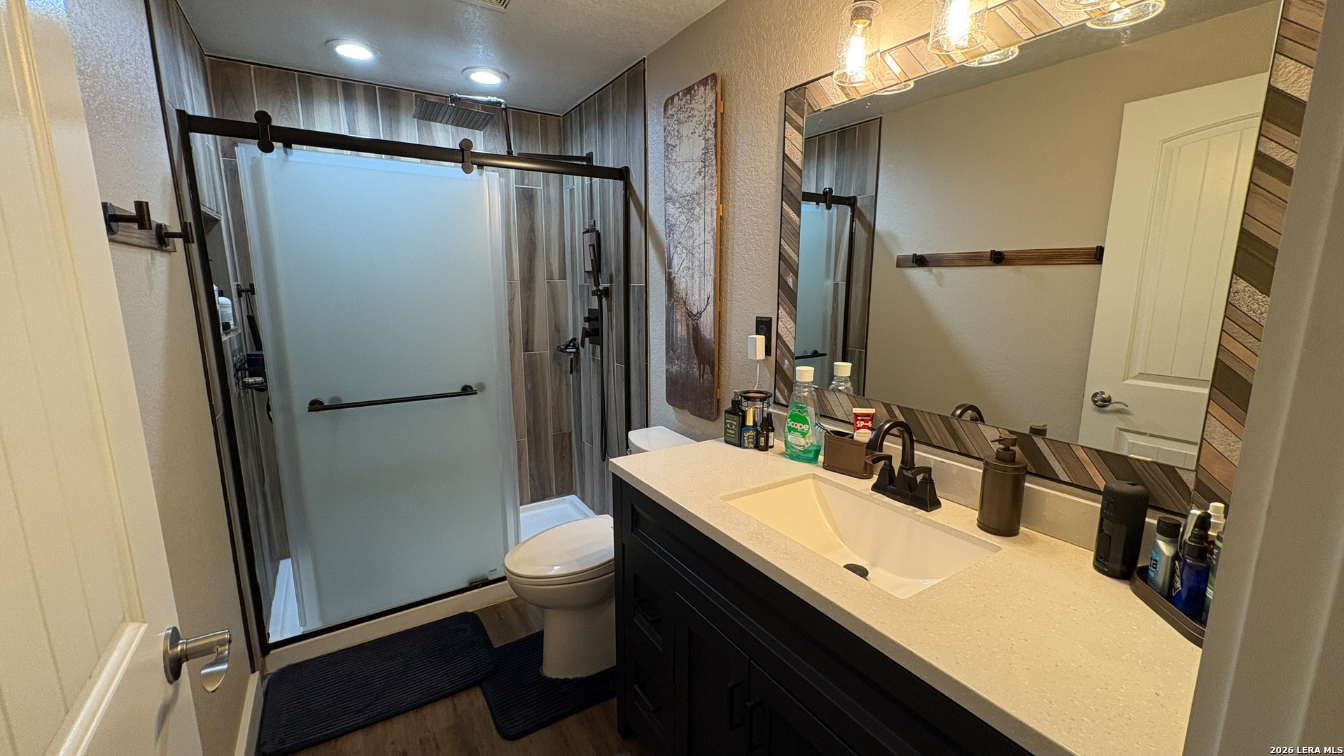 15019 County Road 310 Rocksprings, TX 78880 - Photo 26 of 90 a bathroom with a double vanity sink toilet and shower