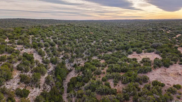 an aerial view of a house with a yard table and chairs