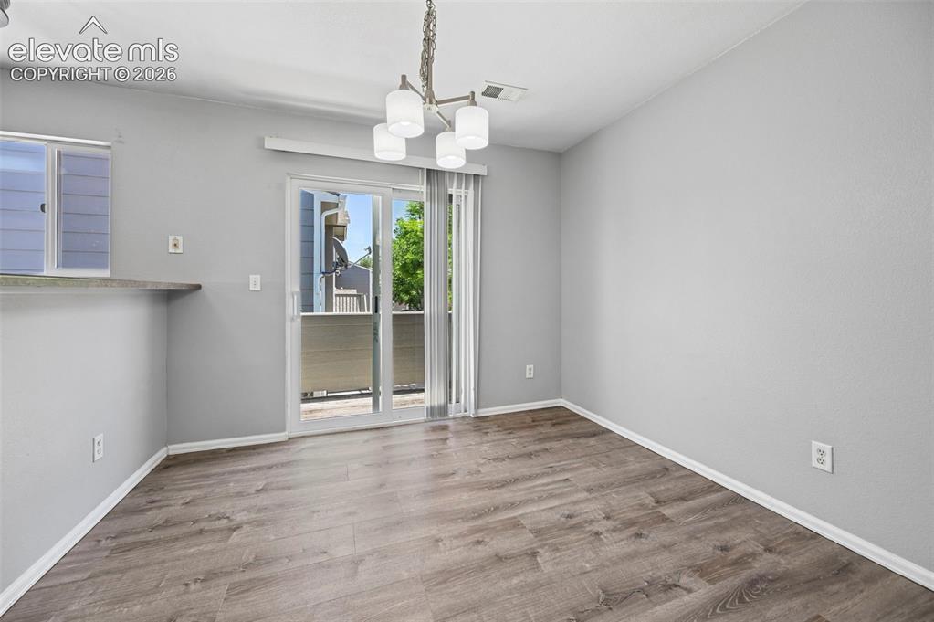 431 Kitfield View Colorado Springs, CO 80916 - Photo 13 of 27 a view of an empty room with wooden floor and a window
