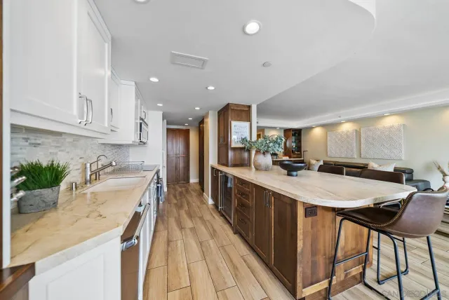 a kitchen with sink and view of living room
