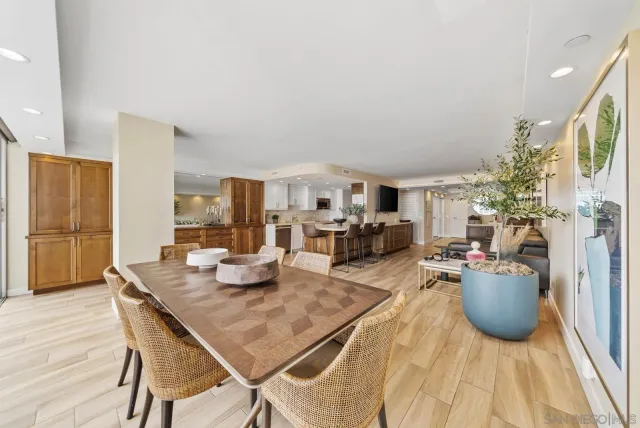 a living room with furniture a flat screen tv and a table