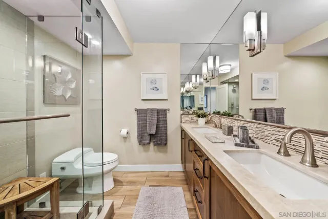 a bathroom with a double vanity sink a mirror and shower