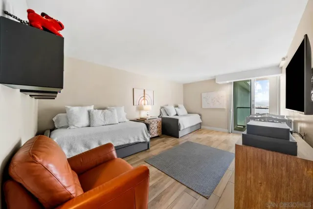 a bedroom with furniture and a wooden floor