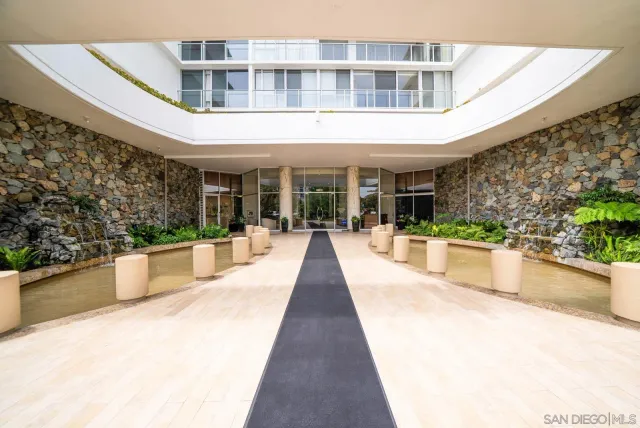 a hallway with a large window and front door