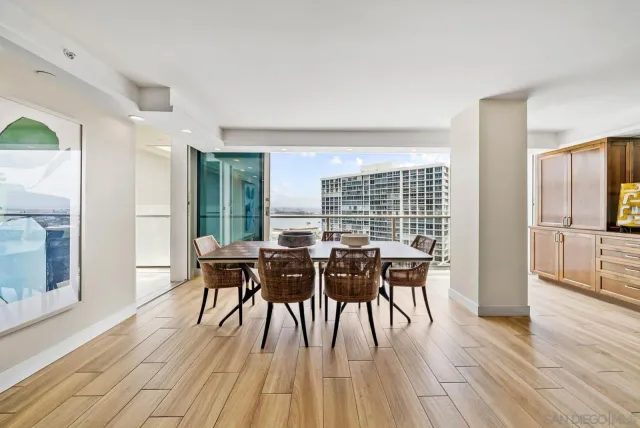 a view of a dining room with furniture and wooden floor