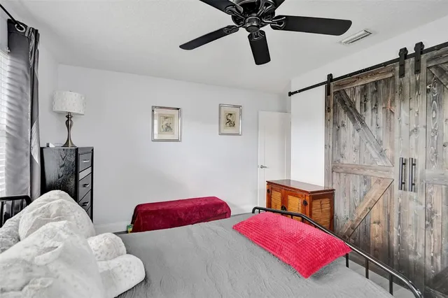 a bedroom with two bed and a chandelier