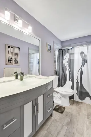 a view of a bathroom with sink mirror and toilet
