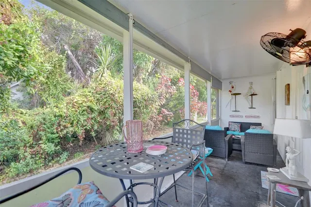 a dining room with furniture and large windows