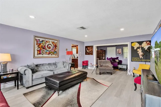a living room with furniture and a floor to ceiling window