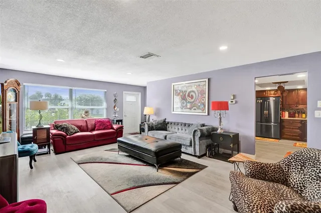 a living room with furniture or couch and a large window