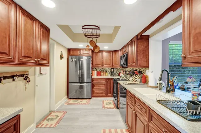 a kitchen with refrigerator and cabinets