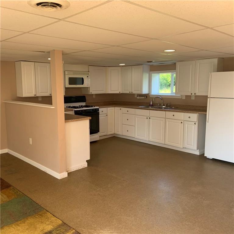 2201 Joiner Road Springboro, PA 16435 - Photo 16 of 25 a kitchen with stainless steel appliances granite countertop a stove a sink and a refrigerator