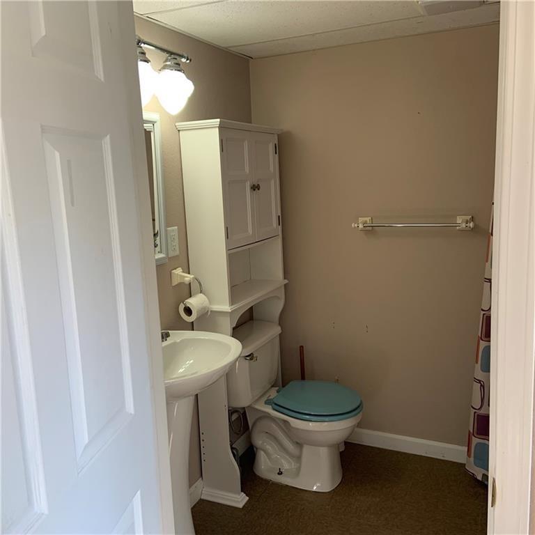 2201 Joiner Road Springboro, PA 16435 - Photo 18 of 25 a white toilet sitting next to a bathroom sink