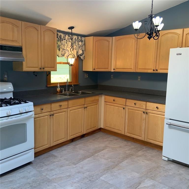 2201 Joiner Road Springboro, PA 16435 - Photo 4 of 25 a kitchen with white cabinets and white appliances