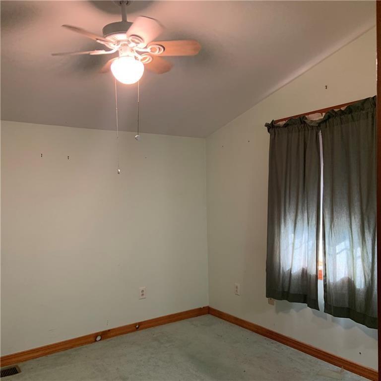 2201 Joiner Road Springboro, PA 16435 - Photo 8 of 25 en empty room with windows and fan