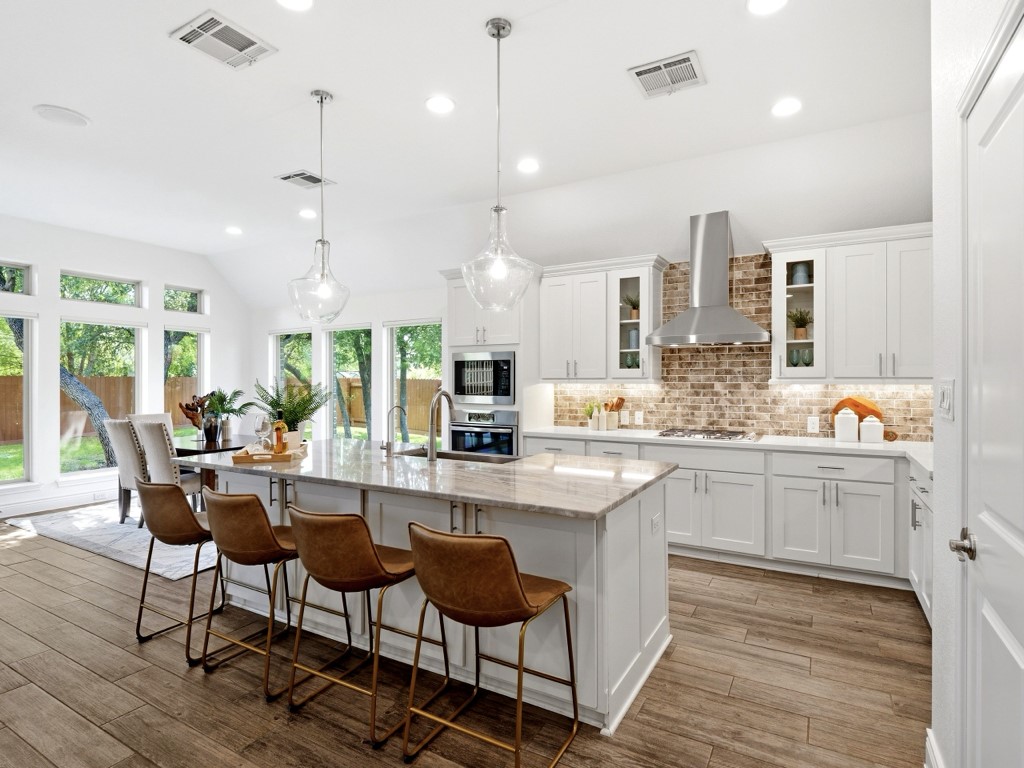 109 Lake Spring Circle Georgetown, TX 78633 - Photo 14 of 38 A well-lit kitchen with sleek appliances and abundant natural light creates an inviting culinary space.