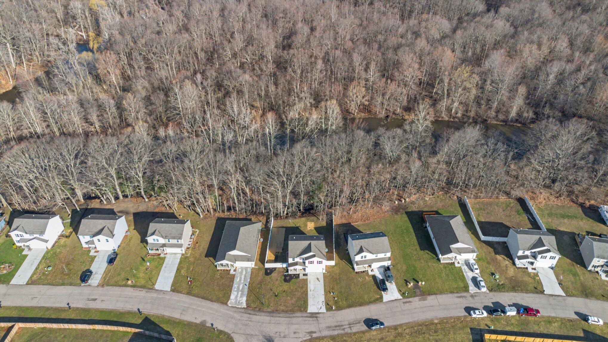 596 Waters Way Watervliet, MI 49098 - Photo 5 of 32 House in middle with fence