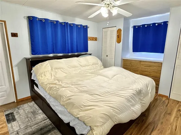 a bedroom with a bed and wooden floor