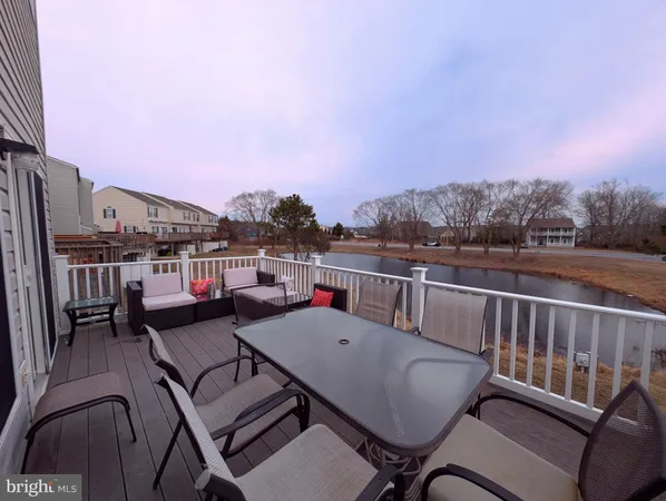 a balcony with table and chairs