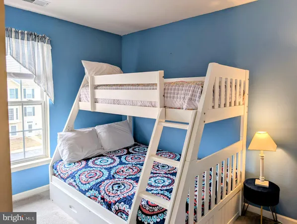 a bedroom with furniture and a window