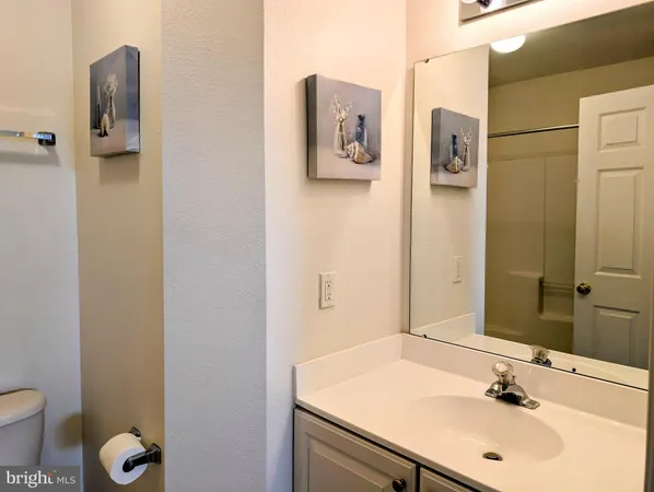 a bathroom with a sink toilet and mirror