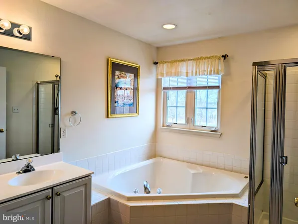 a white bath tub sitting next to a bathroom sink
