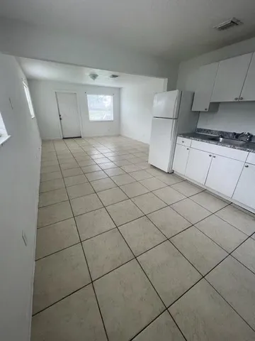 a view of an empty room and a window