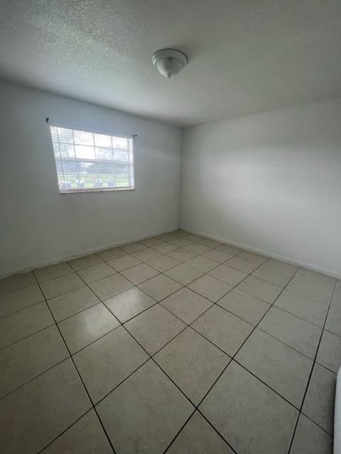 4998 Kirk Road Lake Worth, FL 33461 - Photo 12 of 22 a view of an empty room and a window