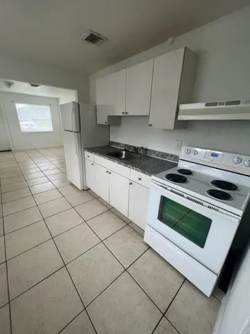 a view of a kitchen and utility room