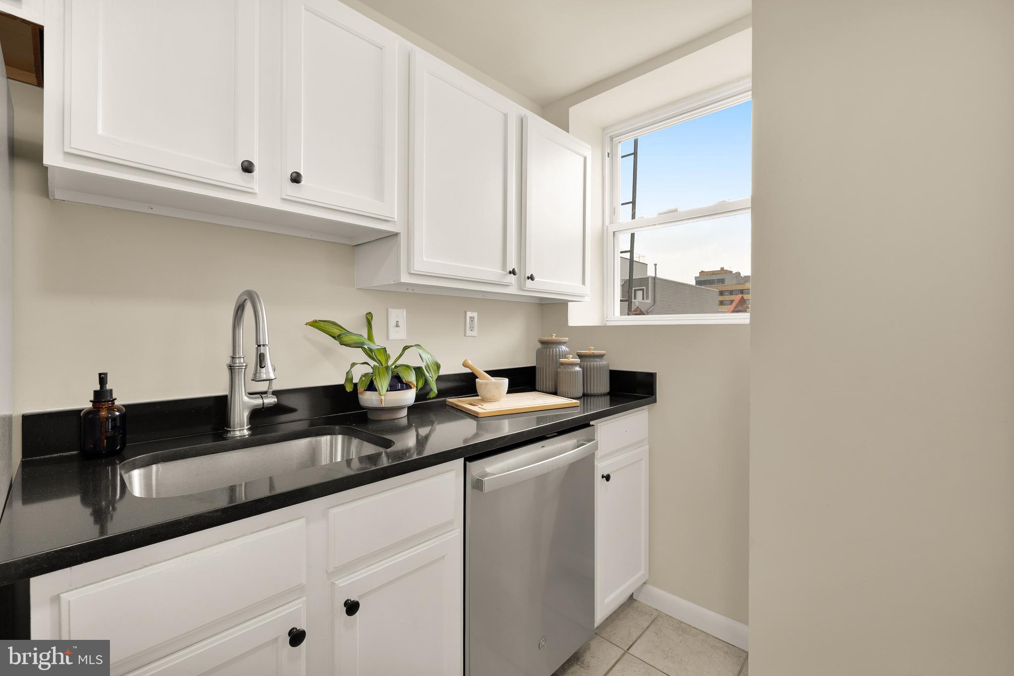 1458 Fairmont Street Northwest, Unit 4 Washington, DC 20009 - Photo 11 of 24 a kitchen with granite countertop white cabinets and a sink