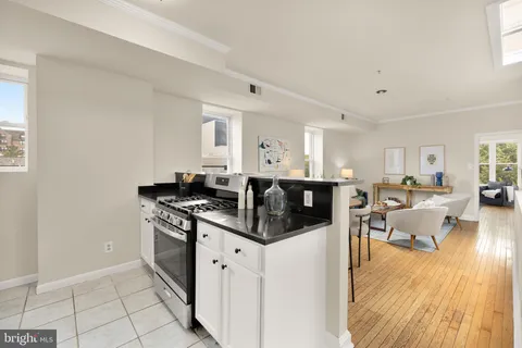 a kitchen with stainless steel appliances granite countertop a stove and a refrigerator