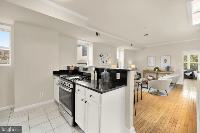 a kitchen with stainless steel appliances granite countertop a stove and a refrigerator