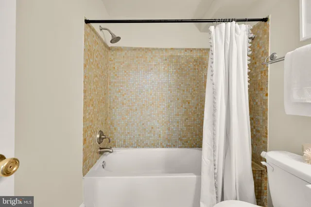 a bathroom with a shower and a bath tub