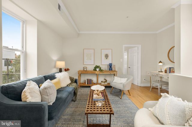 a living room with furniture and a lamp