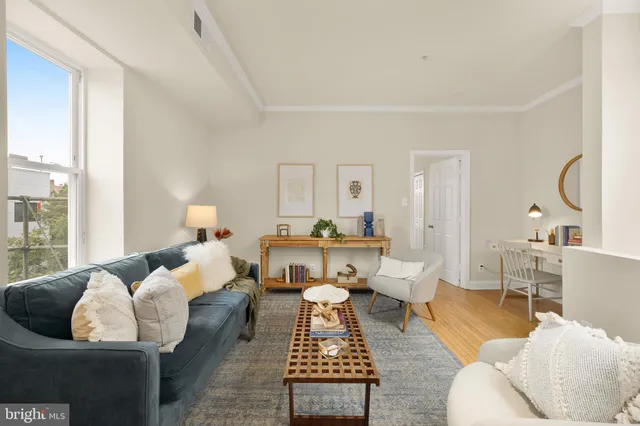 a living room with furniture and a lamp