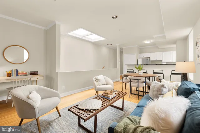 a living room with furniture and kitchen view