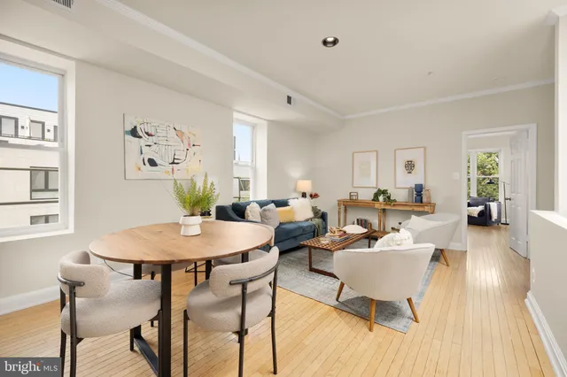 a living room with furniture a wooden floor and a table