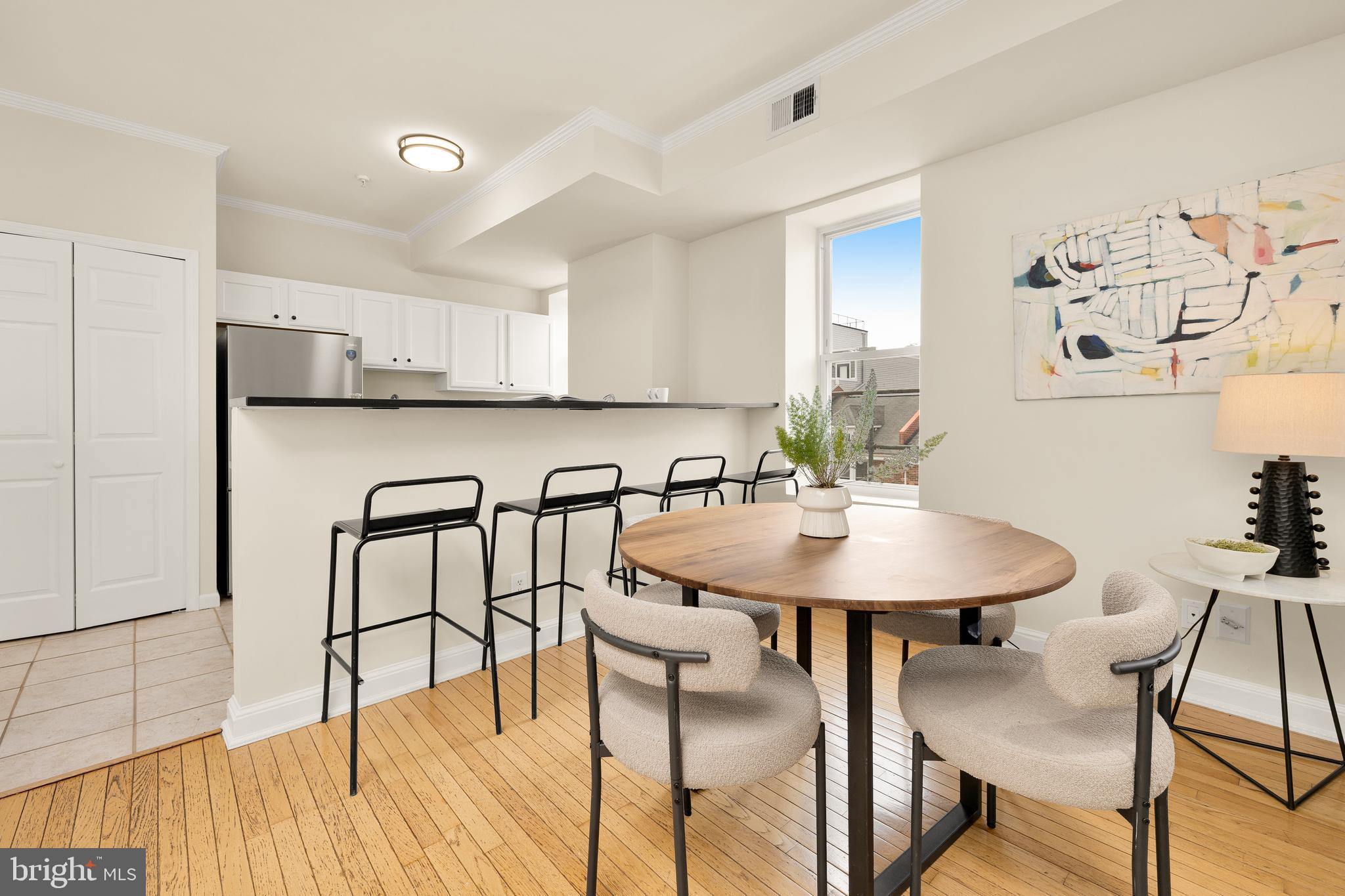 1458 Fairmont Street Northwest, Unit 4 Washington, DC 20009 - Photo 8 of 24 a table with chairs and wooden floor