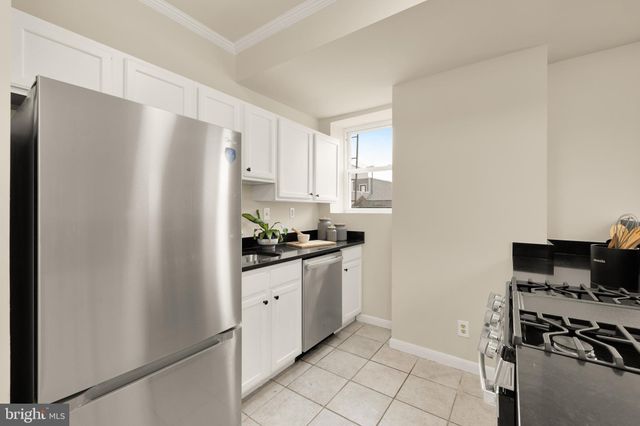 a kitchen with stainless steel appliances a refrigerator sink and stove