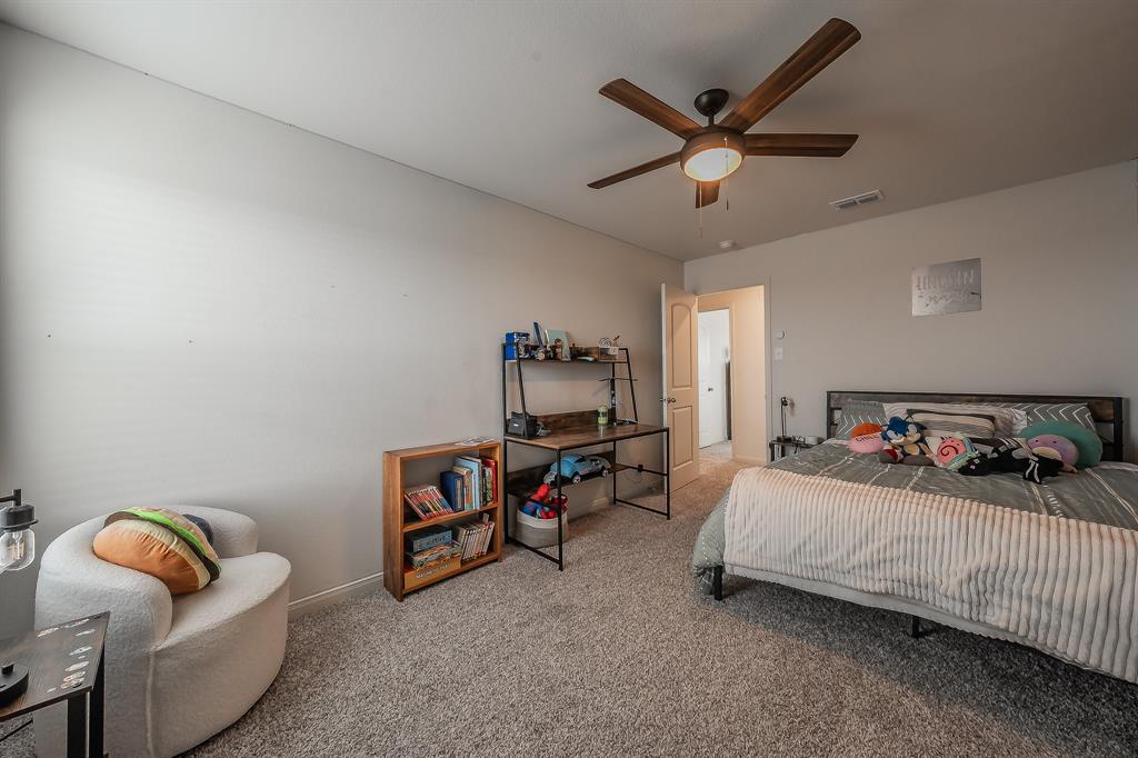 8125 White Sulphur Road Ponder, TX 76259 - Photo 29 of 38 Spacious room featuring neutral-toned walls, plush carpeting, and a contemporary ceiling fan with integrated lighting
