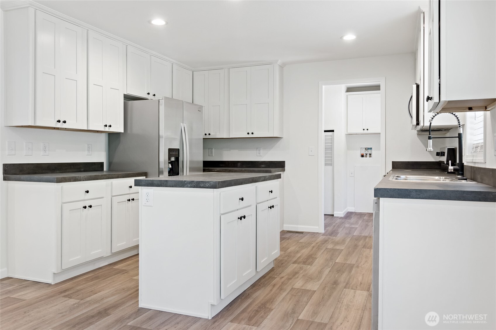 17217 80th Street Southwest Longbranch, WA 98351 - Photo 13 of 39 a kitchen with granite countertop white cabinets and stainless steel appliances