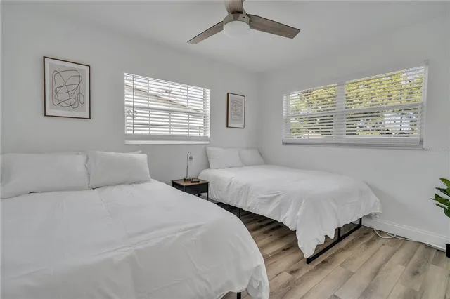 a bedroom with two beds and a window
