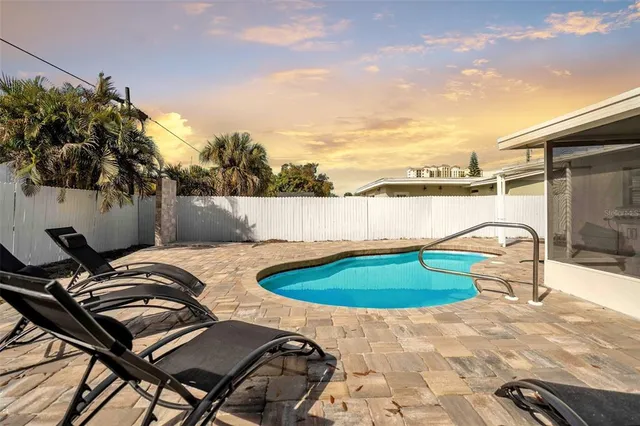 a view of a swimming pool and lounge chair