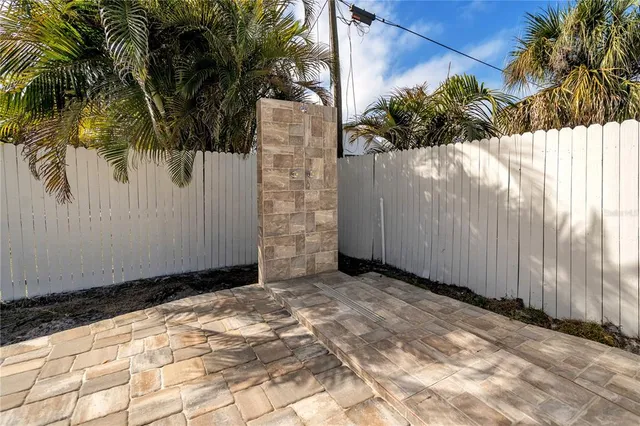 a view of a white house with a yard