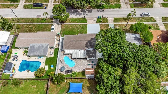an aerial view of a house with a yard and lake view