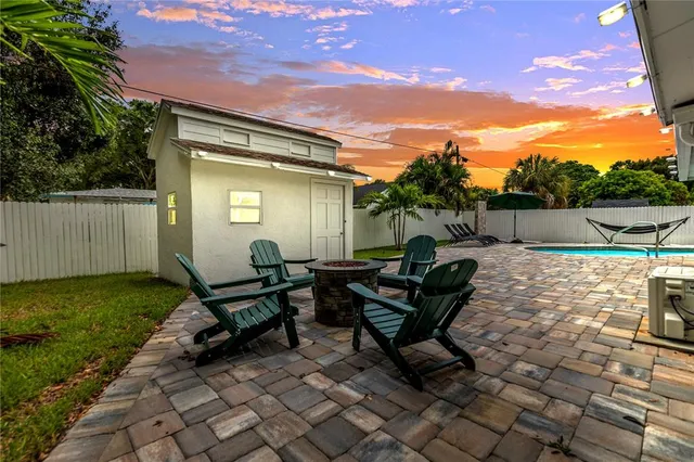 a view of a backyard with sitting area